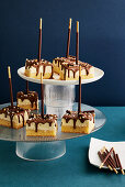 Cheesecake with chocolate icing on a stick