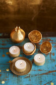 Gold plated lemons and tea lights with glittering ribbon for oriental buffet