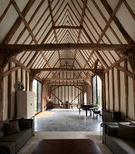 Open living room in a renovated barn with wooden beams