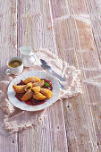 Deep fried potato pockets with plums