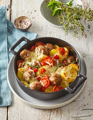 Baked meatballs with potatoes and cheese