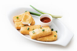 Baked mozzarella sticks with sweet and sour sauce