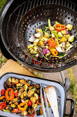 Vegetables in a pan on charcoal grill