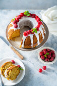 Bundt cake with vanilla glaze and raspberries