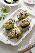 Avocados stuffed with tuna and red onions