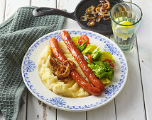 Sausage with barley and mashed potatoes and fried onions