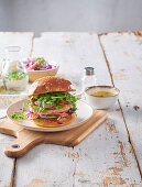 Chicken burger with coleslaw and arugula salad