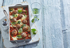 Meatballs au gratin in tomato sauce