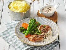 Pepper pork steaks with broccoli and mashed potatoes