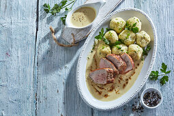 Pork tenderloin with sauce and gluten-free dumplings