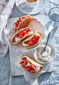 Sweet waffle tacos with strawberries and whipped cream