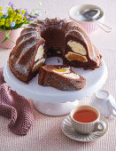 Cocoa sponge bundt cake with curd cheese and peaches