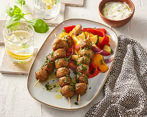 Meatball skewers with pepper salad