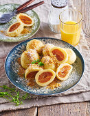 Apricot dumplings with walnut crumbs