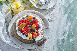 Poppy seed cake with fresh fruit and whipped cream