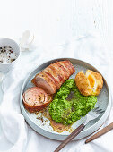 Rabbit roll wrapped in bacon with pea puree and fried egg