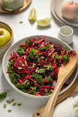 Raw vegetable plate with apple, beetroot, carrots and kale