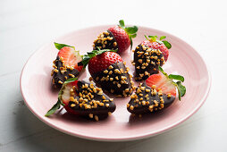 Strawberries with chocolate glaze and almond pieces