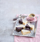 Bicolour cake slices with nuts and chocolate