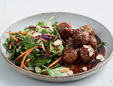 Sticky maple syrup pork meatballs with salad