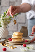 Fluffy Japanese pancakes with honey and raspberries