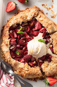 Strawberry and rhubarb galette with almonds and vanilla ice cream
