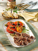 Grilled steak skewers with tomato salad