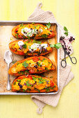 Baked stuffed sweet potatoes with vegetables and ricotta