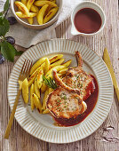 Fried pork chops with plum sauce and potato noodles