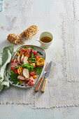 Chicken salad with grilled peaches, ham and rocket salad