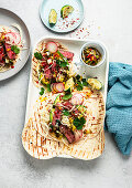 Steak tacos with spring onions and salsa