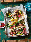 Steak tacos with spring onions and salsa