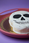 White Halloween cake with skull and crossbones