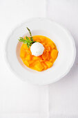 Coconut ice cream on melon ragout with peppermint