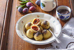 Potato dumplings with plums and poppy seed butter