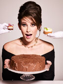 Model with chocolate cake and pastries
