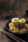 Asian noodle soup with egg and beef
