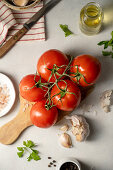 Vine tomatoes and ingredients for tomato sauce