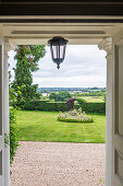 View of a well-tended garden from the entrance area of a country house