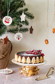 Christmas fruit cake decorated with shortbread trees and redcurrants