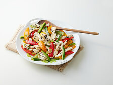 Fried chicken strips with vegetables and sesame seeds