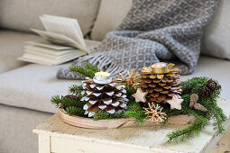 Homemade candle holder made from pine cones