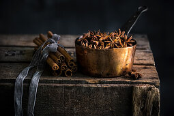 Star anise and a bundle of cinnamon, copper pot