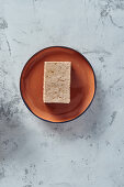 A block of smoked tofu on a plate