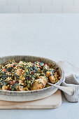 Hearty dumpling casserole with spinach and sultanas (vegan)