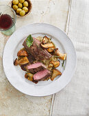 Roasted saddle of venison with mushrooms and aubergine purée