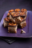 Vegan chocolate and vanilla sponge cake with chocolate icing and salted pretzels