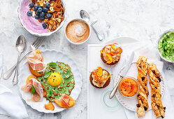 Healthy brunch with cupcakes, muesli bars and pesto fried egg