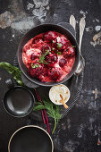 Beetroot balls in an onion and fig sauce with sour cream