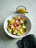 Pulled pepper salmon salad with cucumber, mango and passion fruit dressing